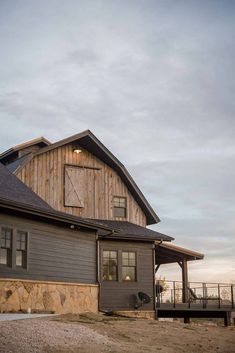 a large barn with a wooden roof and windows