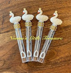 four pens with ducks on them are sitting on a table next to the words donna's little treasures