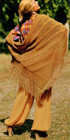 a woman wearing a brown shawl and yellow pants