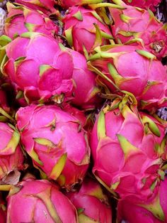 dragon fruit is piled on top of each other