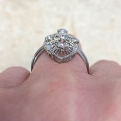 A stunning and very rare Edwardian antique navette ring, featuring an old European cut diamond in the center that is surrounded by filigree and adorned with diamonds around the edge. The center diamond weighs approximately 0.30 carats, I color and VS2 clarity. This ring is made in platinum. This exquisite ring was handcrafted during the beginning of the Edwardian era, circa 1900.
The approximate measurements of this ring including the surrounding filigree is approximately 26mm x 11.85mm.
This ri Navette Ring, The Edwardian Era, European Cut Diamond Ring, Estate Diamond Jewelry, Marquise Cut Diamond, Platinum Engagement Rings, Edwardian Era, European Cut Diamonds, Diamond Color