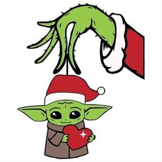 an image of a baby yoda holding a heart in his hand and wearing a santa hat