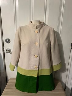 Elegant vintage coat from the 80-90s Authentic vintage garment in great used condition, no flaws. No size but measurements are in photos, fits like a M/L Message me if you have any questions. Vintage Single-breasted Outerwear With Stand Collar, Vintage Stand Collar Winter Blazer, Vintage Khaki Winter Blazer, Green Fitted Long Coat, Vintage Outerwear With Stand Collar And Buttons, Vintage Stand Collar Blazer For Work, Vintage Blazer With Stand Collar For Work, Long Sleeve Outerwear With Button Closure In Vintage Style, Retro Beige Blazer For Fall