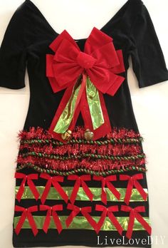 a black dress with red and green bows on it