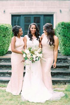 three bridesmaids standing together in front of a house