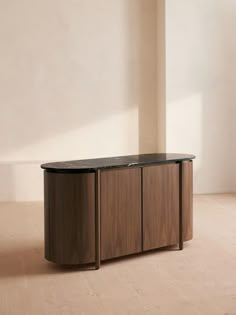 a large wooden cabinet sitting on top of a hard wood floor next to a white wall