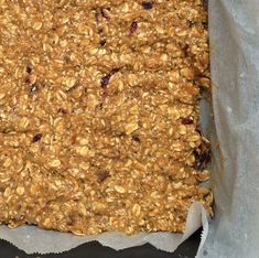 an oatmeal and raisin granola bar in a baking pan, ready to go into the oven