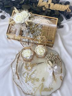 two trays with flowers and wedding decorations on them