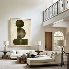 a living room filled with furniture and a painting on the wall