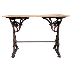 an old wooden table with iron legs and a marble top, on a white background