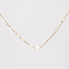 A simple, yet standout piece. The Ariana Single Pearl Necklace brings new life to a classic. This golden necklace is designed to bring a classic touch to a petite piece that you can wear every day both layered and alone. MATERIALS & SIZE Material: 14k Gold Filled Chain and Glass Pearl Measurements: 14 in. Closure: Lobster Clasp Extender: 2 in. View Size Guide JEWELRY CARE Tarnish resistant, hypoallergenic, safe for sensitive skin Handmade with ♡ in New York - To maintain the beauty of your jewel Single Pearl Necklace Nordstrom, Luxury Minimalist Single Strand Pearl Necklace, Single Pearl Necklace Tiffany & Co., Single Pearl Necklace, Single Pearl, Golden Necklace, Brass Chain, Gold Filled Chain, New Life