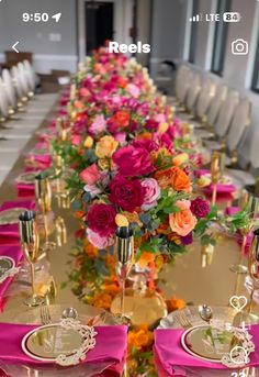 a long table with pink and orange flowers on it