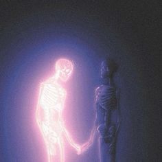 a skeleton standing next to a lit up human figure