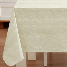 a white table cloth on top of a wooden table