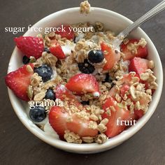 a bowl filled with granola, yogurt and strawberries