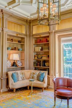 a living room filled with furniture and a chandelier