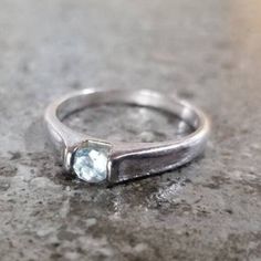 Pretty full cut blue topaz set in 925 silver band. East to West set for a unique look. Marked 925 on interior side of band. Great gift or engagement ring for a blue topaz lover.  SIZING Unmarked Sizer says it's a 7. See pics. Ships fast and free, always. Blue Topaz Ring With Tension Setting For Promise, Silver Solitaire Topaz Promise Ring, Modern Blue Topaz Birthstone Ring For Promise, Modern Blue Topaz Birthstone Promise Ring, Blue Topaz Ring With Tension Setting For Anniversary, Blue Topaz Ring With Bezel Setting For Promise, Silver Topaz Promise Ring With Birthstone, Anniversary Blue Topaz Ring With Tension Setting, Silver Topaz Promise Ring With Tension Setting