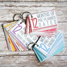 several calendars with numbers on them sitting next to each other in front of a wooden background