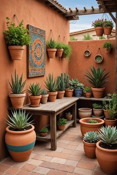 there are many potted plants on the outside of this house and in front of it is a wooden bench