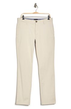 A solid hue makes these chino pants a versatile, everyday classic staple for your closet. 9" rise, 32" inseam (size 32x32) Trim fit Zip fly with button closure 2 front slash pockets; 2 back button welt pockets 97% cotton, 3% spandex Machine wash, tumble dry Imported Model stats: 6'1" height, 32" waist. Model is wearing size 32x32. Solid Color Slim Fit Straight Leg Chinos, Slim Fit Straight Leg Solid Chinos, Slim Fit Straight Leg Chinos, Classic Tapered Chino Cotton Twill Bottoms, Straight Chinos With Welt Pockets, Classic Slim Fit Mid-rise Chinos, Beige Slim Fit Straight Leg Chinos, Solid Chinos With Straight Hem For Everyday, Spring Work Pants With Straight Fit And Welt Pockets