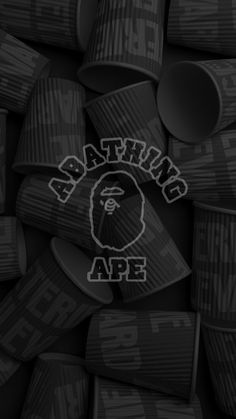 the bathing ape logo is on top of many plastic cups that are stacked up together