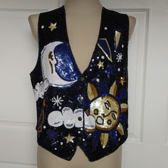 Navy Back; With Ties. Front: 4 Snaps Sequins And Beads. Sun, Moon And Stars Design. Hand Beaded; Extra Beads. Apx> Bust: 42" Flat: 21" Armpit To Hem: 9" Shoulder To Hem: 20" Mid Back To Hem: 19" Mid Center To Hem: 23" Moon And Stars Design, Sun Moon And Stars, Stars Design, Moon And Stars, Star Designs, Sun Moon, Hand Beading, Fashion Tops, Blue Gold