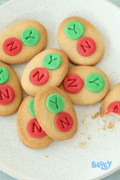 some cookies are on a plate with letters and numbers