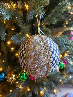 a christmas ornament hanging from the top of a tree