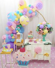 an image of a birthday party with balloons and cupcakes on the table in front of it