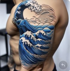 a man's arm with an ocean wave tattoo on it