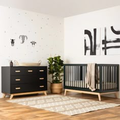 a baby's room with two cribs and a rug on the floor