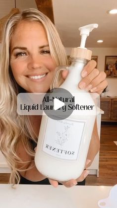 a woman holding a bottle of liquid in front of her face and the words, all natural liquid for every skin type