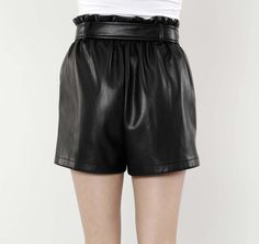 Jazz up your wardrobe with our Faux Leather Paper Bag Shorts. High-waisted and featuring a ruffled waistline cinched with a wide belt, these on-trend shorts add a touch of contemporary style to any ensemble. The paper bag design offers a playful and feminine aesthetic that contrasts with the edgy vibe of the faux leather material, giving you a unique piece that makes a defiantly bold statement. Faux leather Paper Bag waist Belted Available in Black and Camel Dry Clean Polyurethane Final Sale Ite Paper Bag Shorts, Feminine Aesthetic, Leather Shorts, Cool Suits, Leather Material, Suits You, Vegan Leather, Contemporary Style, Comfort Fit