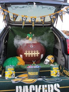 the trunk of a car decorated with football decorations