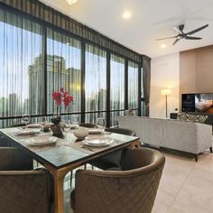 a dining room table with chairs and a ceiling fan