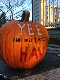 an orange pumpkin with the words yee and dare i say haia written on it