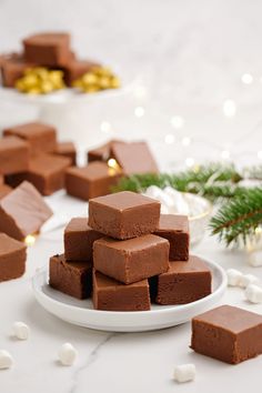 a white plate topped with brownies on top of a table next to christmas decorations