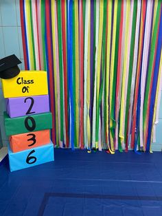 colorful graduation decorations in front of a blue floor