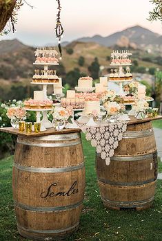 the wedding cake is on top of two wooden barrels