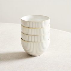 three white bowls stacked on top of each other