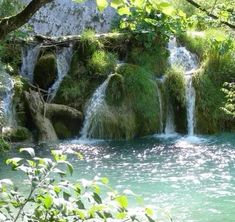 there is a waterfall that has moss growing on it