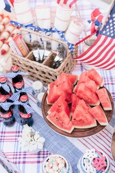 watermelon slices are displayed on a picnic table with american flags and patriotic decorations