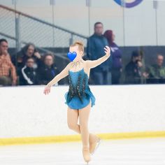 a female figure skating on an ice rink