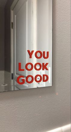 a mirror with the words you look good on it