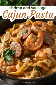 shrimp and sausage cajun pasta in a black bowl with parsley on the side