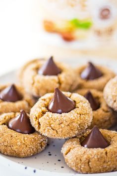 chocolate chip cookies on a white plate with milk in the background