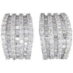 An incredible huggie hoop style earring. Unique in design and full of SPARKLE! 5.81 carats of F color VS clarity baguette and round brilliant cut diamonds set in 18k white gold. .57 inches at its widest point, .86 inches tall -- approximately. Luxury Baguette Diamond Earrings For Party, Luxury Baguette-cut Diamond Earrings For Wedding, Luxury Round Cut Baguette Diamond Earrings, Luxury Baguette Diamond Hoop Earrings, Luxury White Baguette-cut Diamond Earrings, Earring Unique, Baguette Diamond Earrings, Bling Ideas, Earrings For Sale