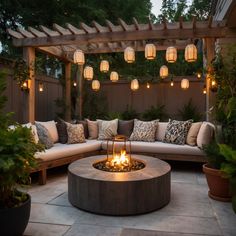 a fire pit surrounded by plants and lights