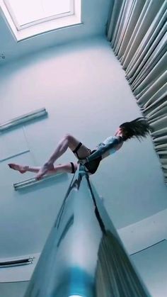 a woman is flying through the air on an escalator with her legs spread out