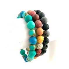 NUMBER 1 & 3 ARE RESERVED.... PLEASE DO NOT BUY.... THANK YOU  Very cute & colorful dyed lava rock bracelets! Three different kinds, one of each style available:  1. Black & Gray-RESERVED  2. Aqua Green & Blue 3. Brown Pink Yellow Mix-RESERVED  Each bracelet is beaded on clear strong elastic, and measures about 7 inches inside. These can be worn with any style outfit or add to your favorite stacking bracelets! Adjustable Lava Stone Beaded Bracelets, Casual Adjustable Lava Stone Beaded Bracelets, Casual Multicolor Hypoallergenic Bracelets, Casual Lava Stone Beaded Bracelets, Casual Lava Stone Beaded Bracelets For Everyday, Casual Everyday Lava Stone Beaded Bracelets, Casual Multicolor Hypoallergenic Beaded Bracelets, Casual Lava Stone Bracelet With Natural Stones, Casual Multicolor Stretch Bracelet For Healing